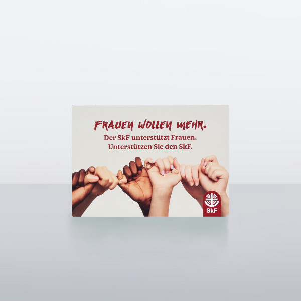 Postkarte mit der Aufschrift „Frauen wollen mehr“ und mehreren Händen, die sich verbinden